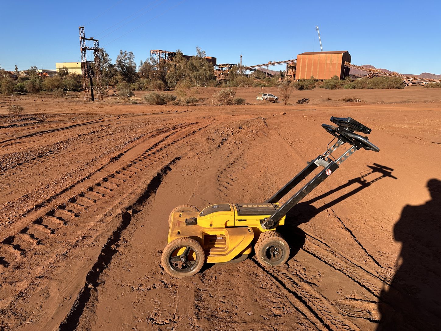 Whitech ground penetrating radar cart set up on red dirt at an industrial site