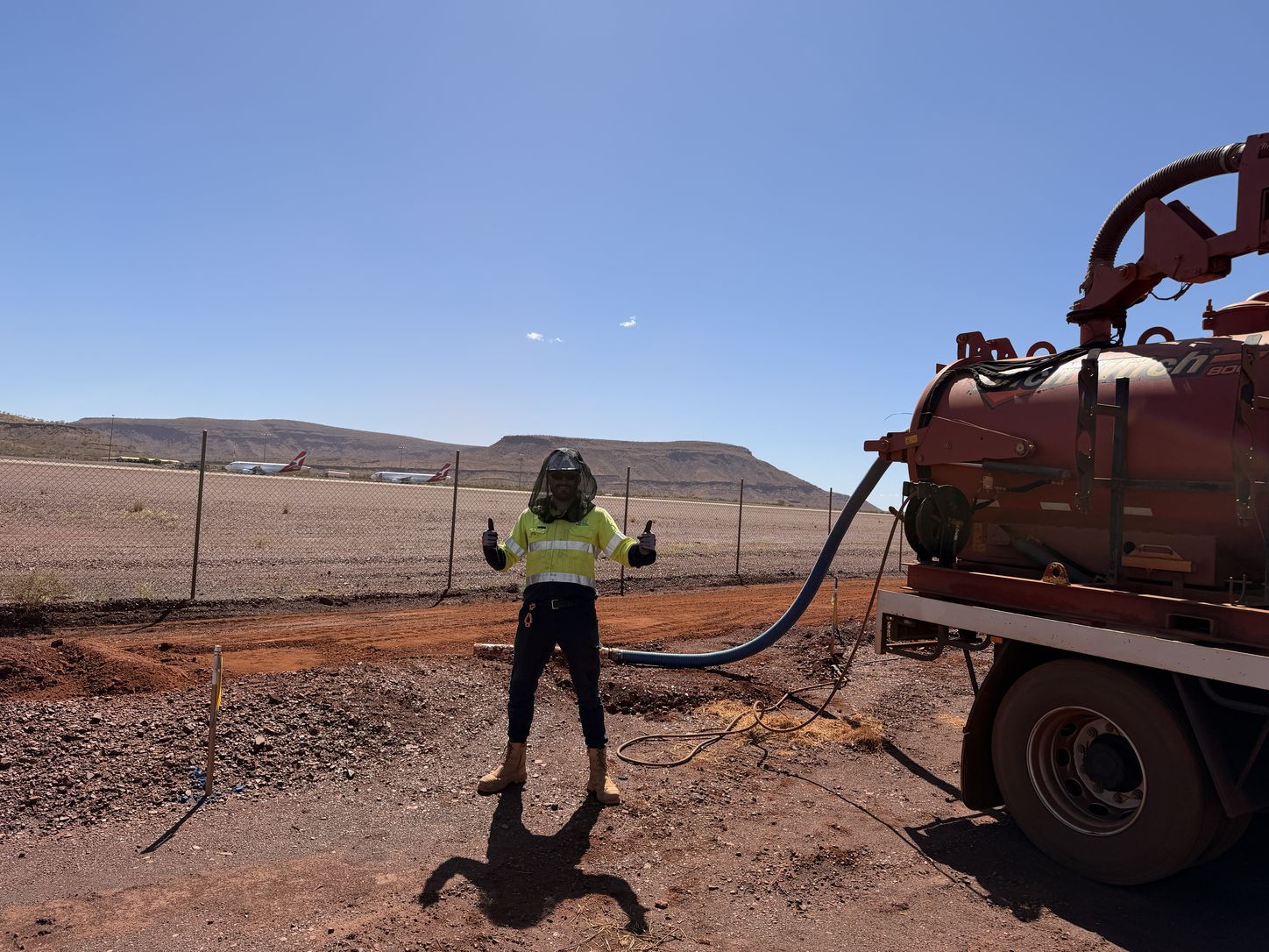 Whitech operator beside a trailer-mounted vacuum excavation unit on a regional site